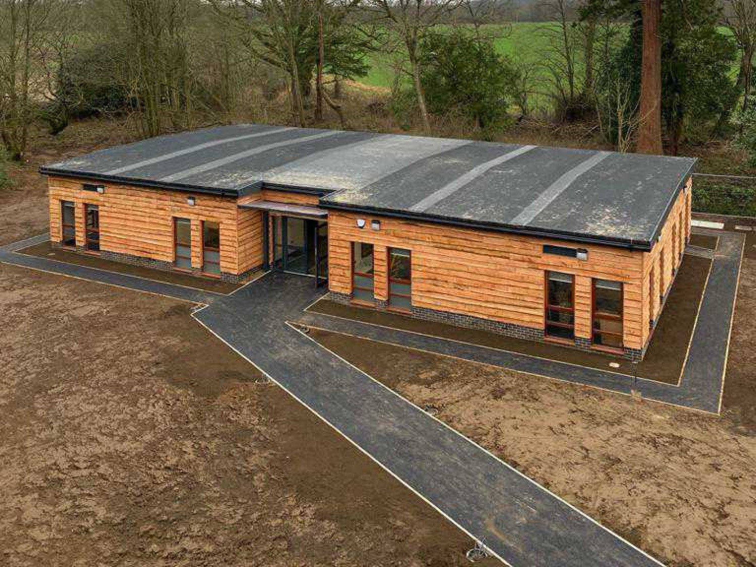 Exterior of the bespoke 'ARC' modular building at Alderbrook School, designed by Modulek with timber cladding and accessible ramp, specifically for Year 7 and 8 pupils with Autism.