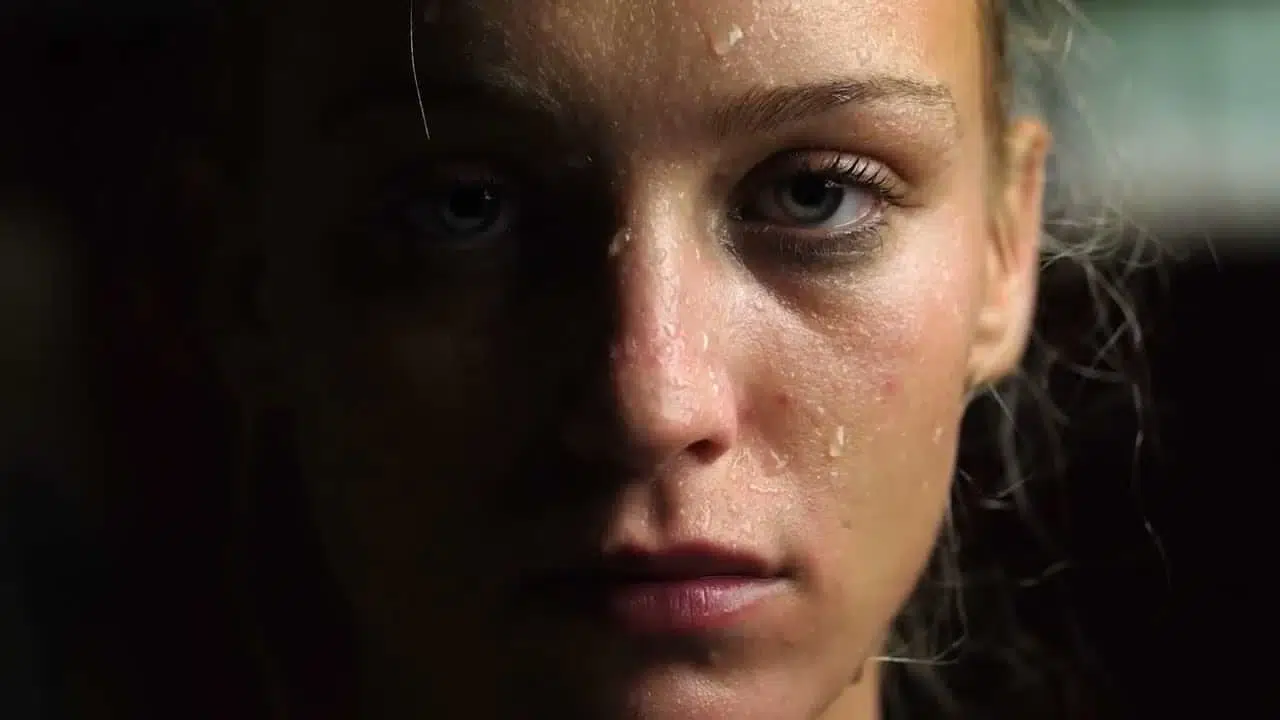 Close-up portrait showing intensity and determination, representing elite athletic performance in modern sports facilities built by Modulek