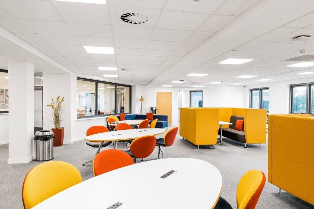 Emmanuels new school modular classroom. With yellow and orange chairs and tables.
