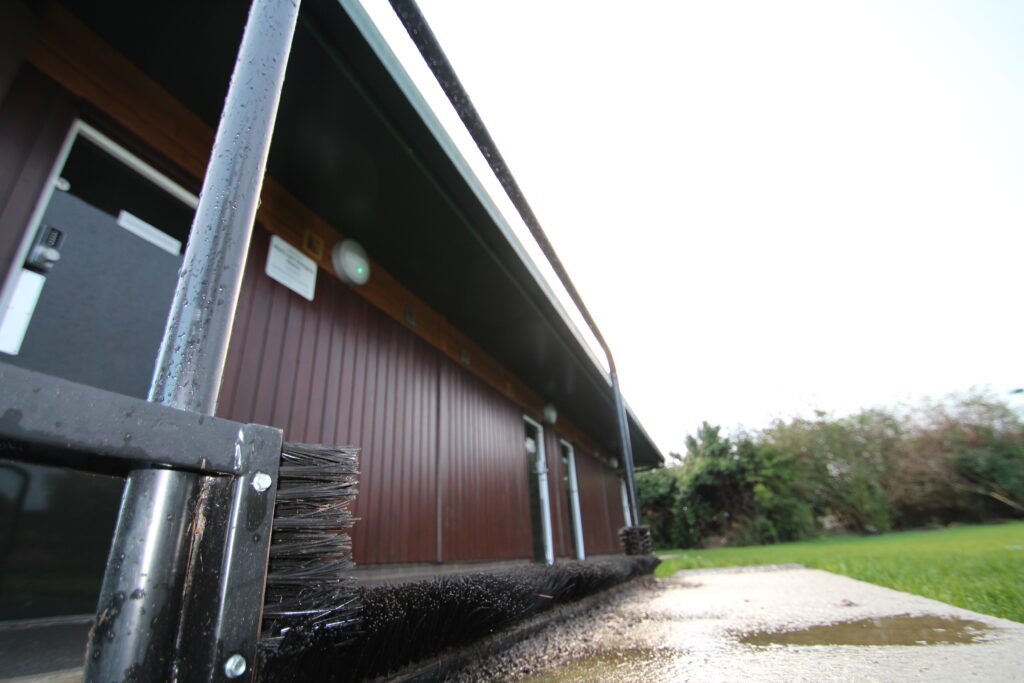 Completed modular sports facility with landscaped surroundings and modern exterior Exterior view of a modular sports facility building with outdoor access and contemporary design