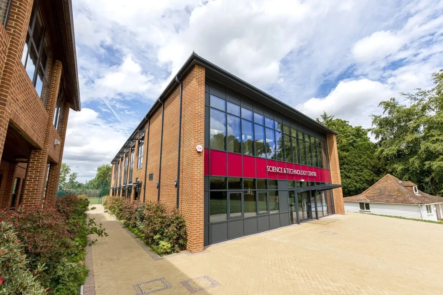 A modern science block at a Surrey school, designed as a bespoke modular school building that complements the traditional brick architecture of the main campus.