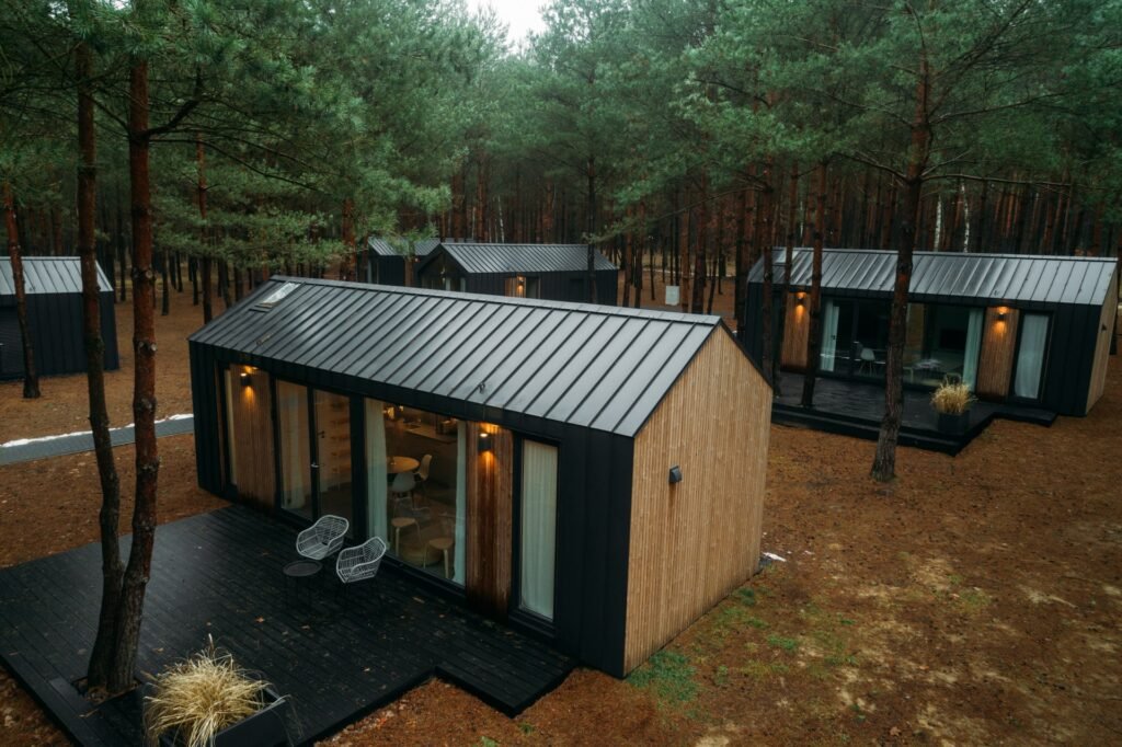 Multiple wooden lodges in a forest built by Modulek named The Haven.